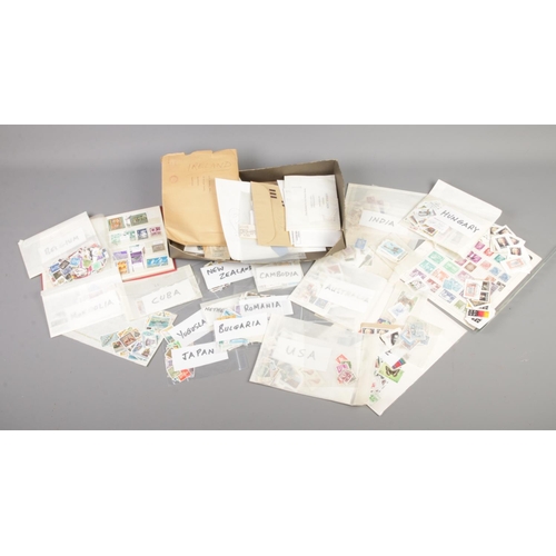 61 - A large collection of loose world and GB stamps, together with a small partly filled album.