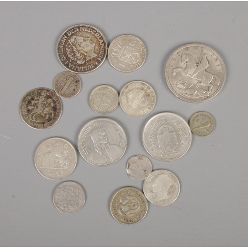 373 - A quantity of international coins, including silver and half-silver examples, to include 1935 crown,... 