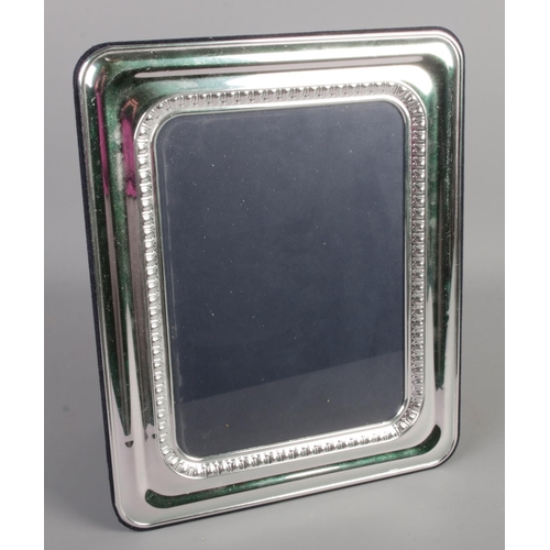 379 - A large silver mounted photo frame. (33cm x 27cm)