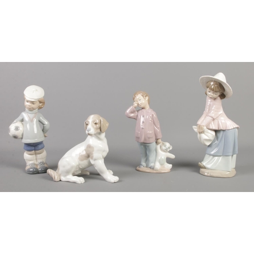 394 - Four Lladro and Nao by Lladro ceramic figures, to incude boy with football and tired boy with bear.