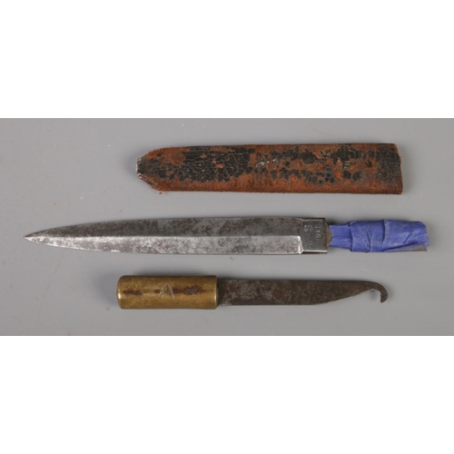 396 - A WWII W-S 1941 fighting knife in part scabbard, together with a trench art fishing net mending knif... 