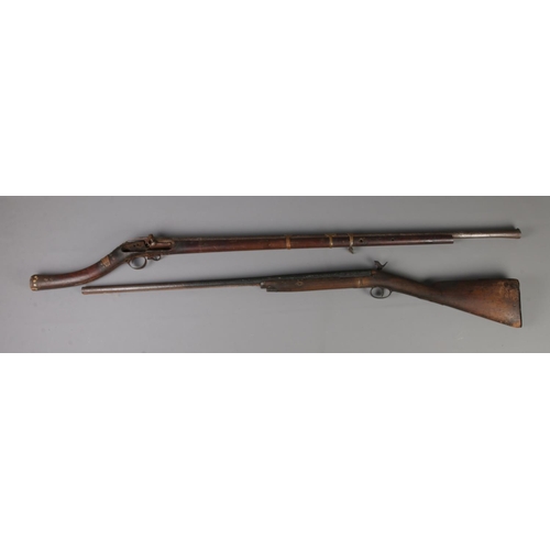 397 - Two Nineteenth Century percussion cap pit rifles; including Eastern example with bone inlay to the h... 