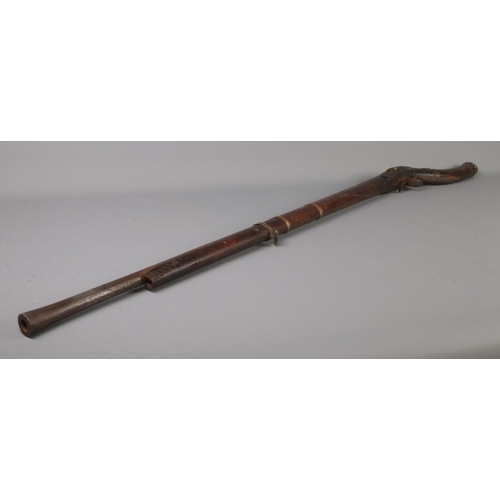 397 - Two Nineteenth Century percussion cap pit rifles; including Eastern example with bone inlay to the h... 