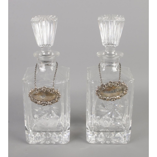 402 - A pair of cut glass decanters bearing silver A. Chick & Sons Ltd labels. Assayed London 1971 and 197... 