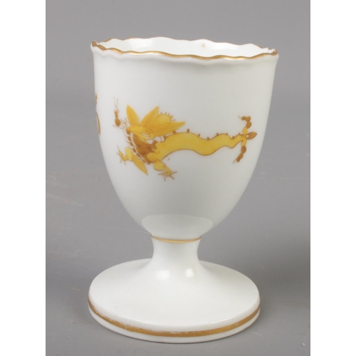 406 - A Meissen porcelain egg cup decorated with dragons.