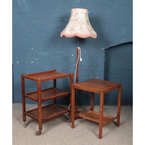 432 - A three tier tea trolley, along with similar table and standard lamp.