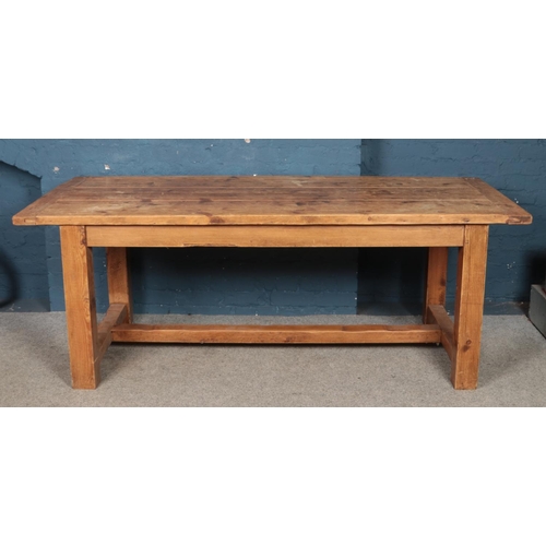 435 - A large pine refectory dining table, with central stretcher. Height: 78cm, Width: 212cm, Depth: 90cm... 