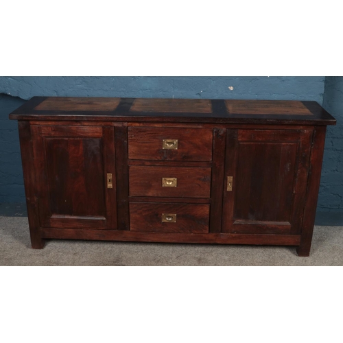 437 - A large hardwood sideboard, featuring a set of three drawers with campaign handles flanked by two cu... 