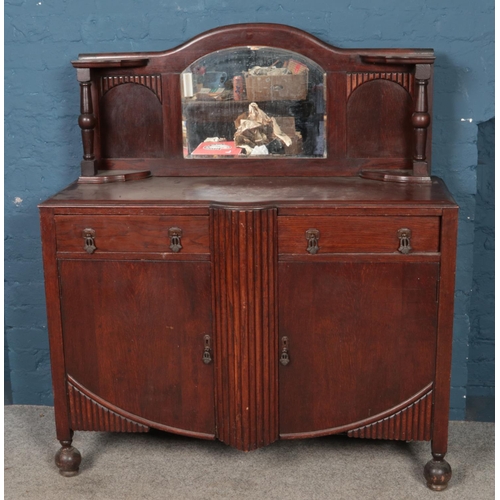 443 - A stained oak mirror back sideboard, with dome top bevel edge mirror. With turned pedestal supports,... 