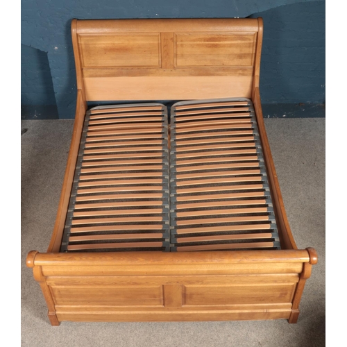 444 - An oak double bed frame. Height: 110cm, Width: 159cm, Length: 227cm.