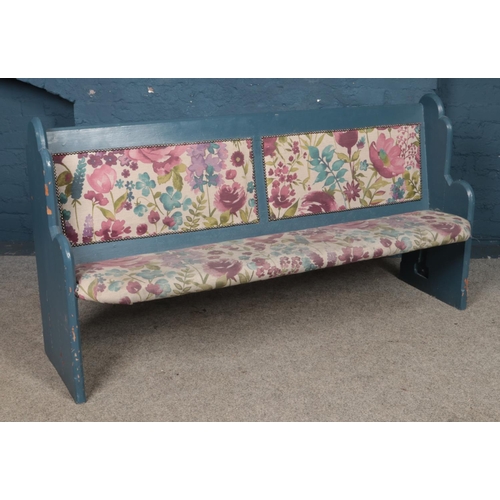 449 - A painted pine pew with floral upholstered seat and pack. Length: 166cm, Height: 86cm.