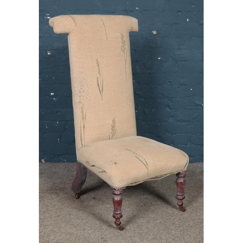 453 - A prayer dieu chair, with turned front feet raised on casters.