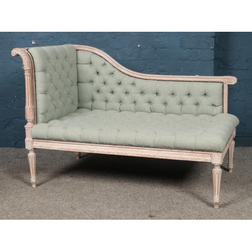 455 - A French chalked corner sofa/chaise lounge of small proportion, with heavily carved detailing and sc... 