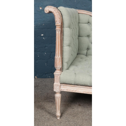 455 - A French chalked corner sofa/chaise lounge of small proportion, with heavily carved detailing and sc... 