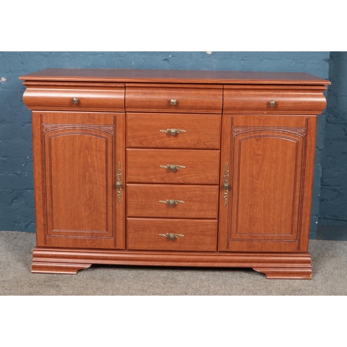 458 - A modern hardwood sideboard. Central drawers flanked by two cupboards.