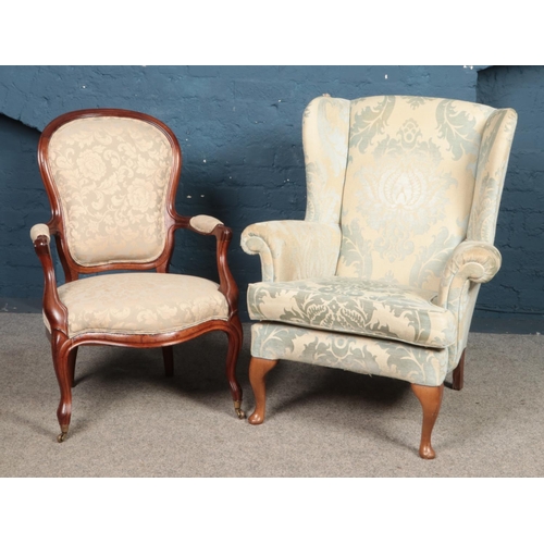 462 - A wingback armchair with floral upholstery and cabriole feet, together with a mahogany spoon back ar... 