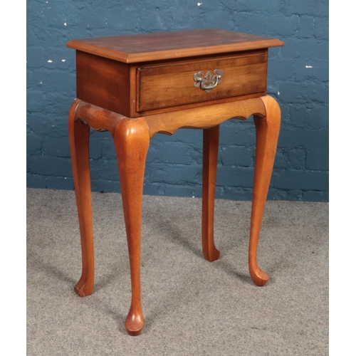 468 - A modern walnut side table with single drawer. Raised on cabriole supports. (75cm x 52cm x 30cm)