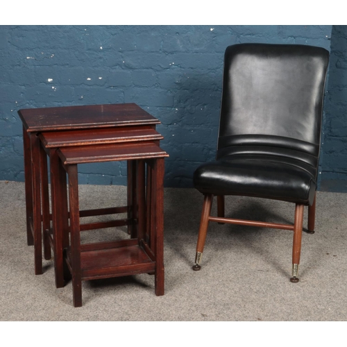 475 - A retro faux leather chair with ribbed seat, together with a nest of three tables.