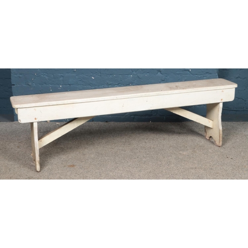 480 - A painted pine bench. 152cm long.