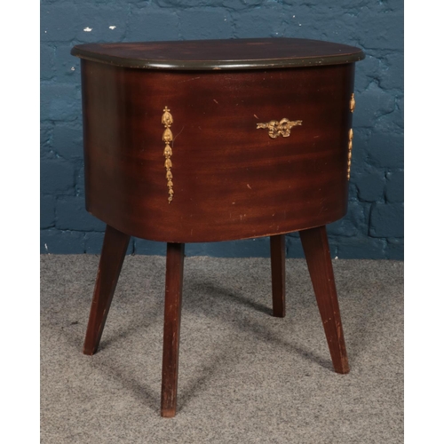 495 - A mahogany lift top sewing box and contents, produced by Morco. 55cm high.