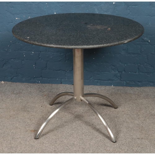 497 - A circular marble topped and chrome table. Table diameter 90cm.