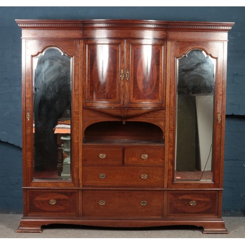 500 - A large Victorian mahogany Compactum, with lower drawer base, bevel edged mirror front, central bow ... 