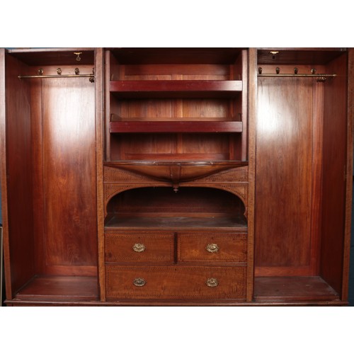 500 - A large Victorian mahogany Compactum, with lower drawer base, bevel edged mirror front, central bow ... 