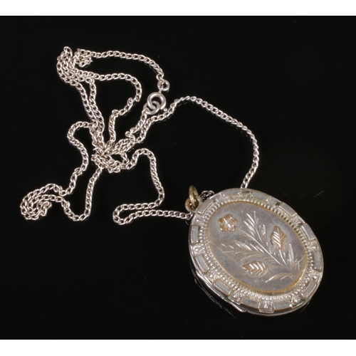 339 - A Victorian white metal locket on silver chain. Total weight 21.69g.