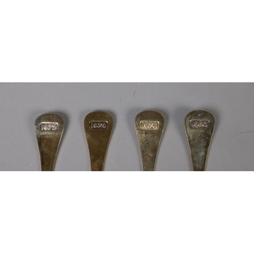 344 - Four Georg Jensen silver gilt year spoons featuring floral enamel decoration. Includes years 1972, 1... 