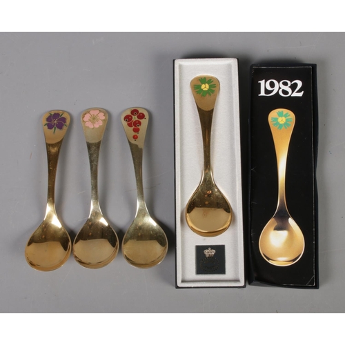 345 - Four Georg Jensen silver gilt year spoons featuring floral enamel decoration. Includes years 1974, 1... 