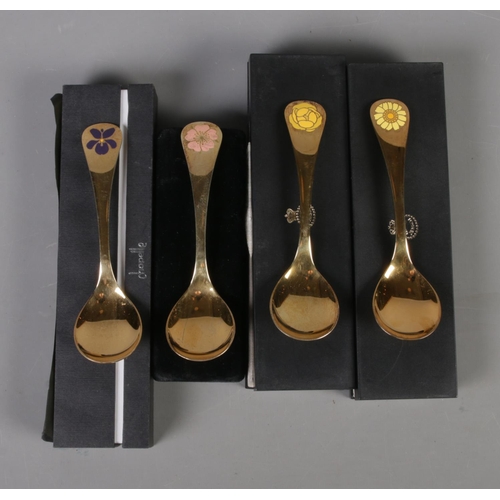 346 - Four Georg Jensen silver gilt year spoons featuring floral enamel decoration. Includes years 1973, 1... 