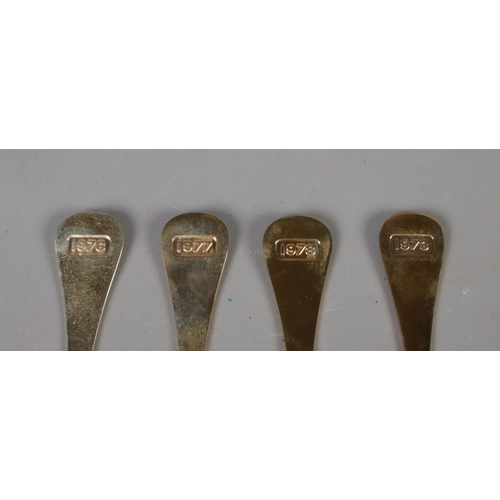 346 - Four Georg Jensen silver gilt year spoons featuring floral enamel decoration. Includes years 1973, 1... 