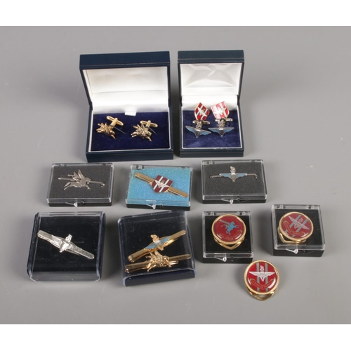 27 - A collection of military themed cufflinks, tie slides, scarf rings, pins, etc.
