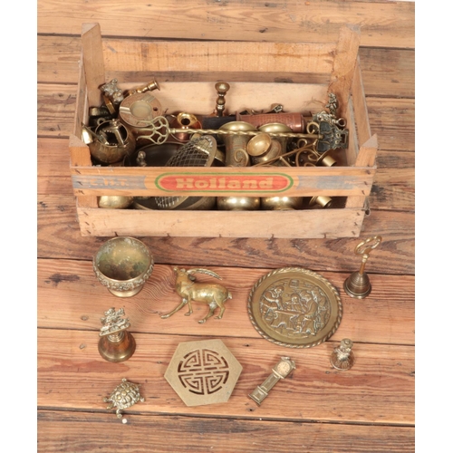 208 - A crate of brass, copper and yellow metal wares including several novelty figures, goblets, etc.