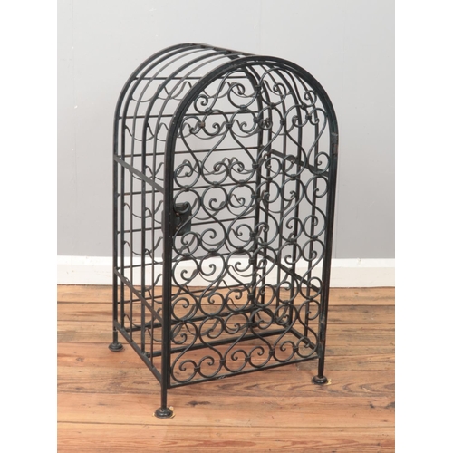 243 - An iron wine rack with hinged door. Space for 26 bottles.