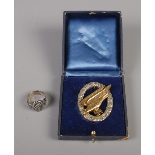 300 - A German WWII Third Reich Fallshirmjaeger Luftwaffe Paratrooper badge and ring (possibly silver). No... 