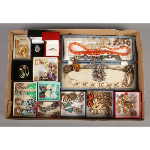 67 - A collection of costume and dress jewellery. Contains necklaces, clip on earrings, brooches and ring... 