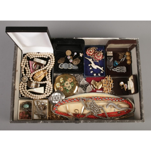 68 - A file containing a collection of vintage costume jewellery; including stick pins, marcasite brooche... 