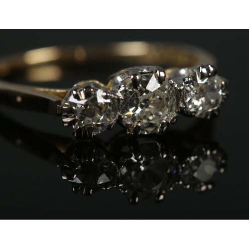 328 - An 18ct Gold and Platinum three stone diamond ring. Largest stone over ¼ct, with a diameter of 5mm. ... 