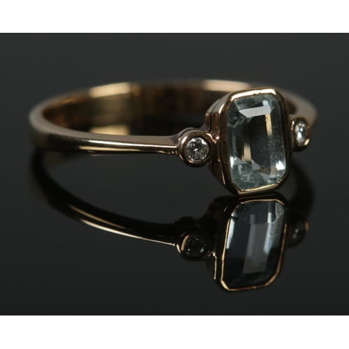 329 - A 9ct Gold, Aquamarine and Diamond ring. Size M½. Total weight: 1.5g.