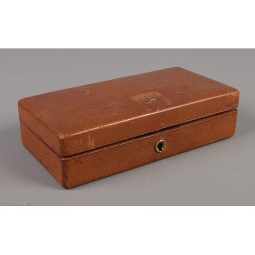 330 - A brown hinged box containing an assortment of yellow metal jewellery. Includes 9ct Gold front and b... 