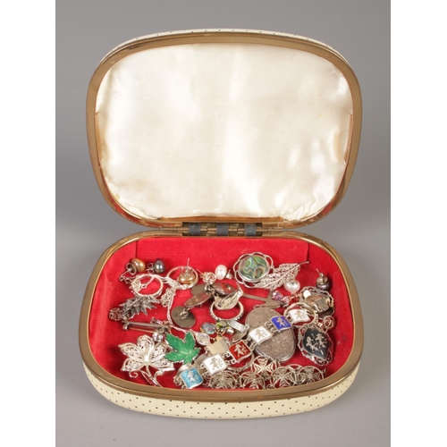 371 - A cream jewellery box containing an assortment of silver jewellery. To include locket, enamel bracel... 