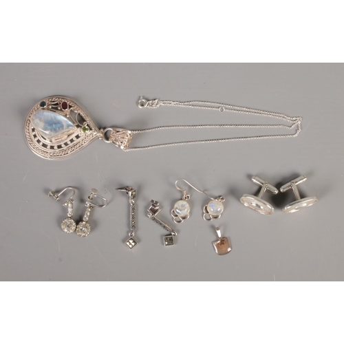 377 - A collection of silver jewellery including earrings, cufflinks and moonstone pendant.