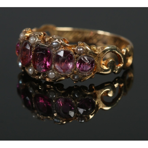 381 - A Victorian Almandine garnet and pearl ring, tests as high carat gold. Size K, 2g.