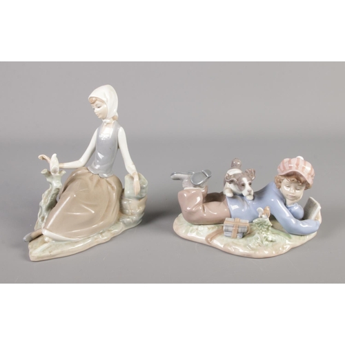 383 - Two Lladro porcelain figures formed as a boy playing with a dog and young girl with bird.