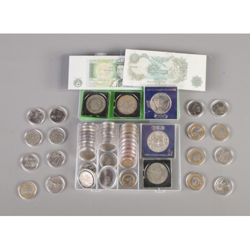 384 - A collection of British coins and banknotes including commemorative 50p's, £2 coins, crowns, etc.