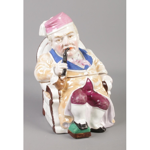 388 - A continental tobacco jar formed as a man smoking a pipe on a chair.