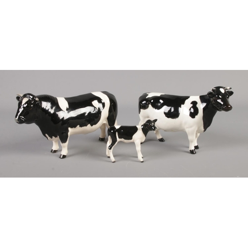 389 - A Beswick Friesian family comprised of bull, cow and calf.