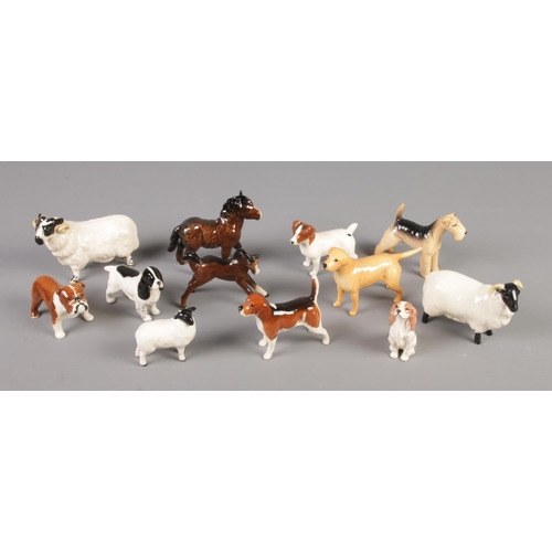 394 - A collection of Beswick animal figures including Ram, Jack Russell, Foal, etc.