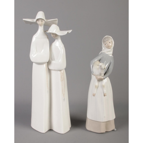 422 - Two Lladro ceramic figure groups, featuring two nuns and lady with sheep. Tallest: 34cm.